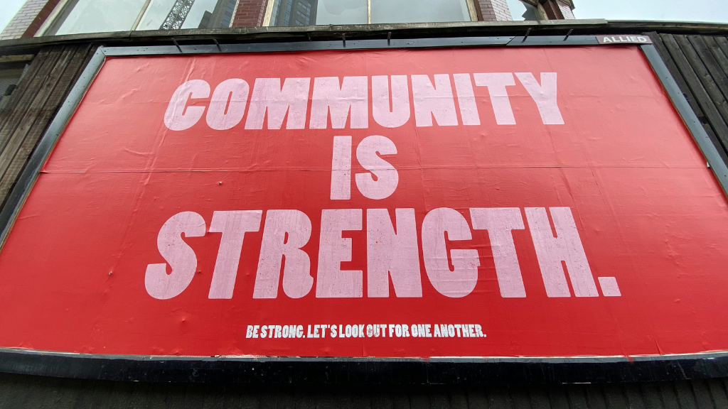 Billboard showing the words 'Community is Strength'